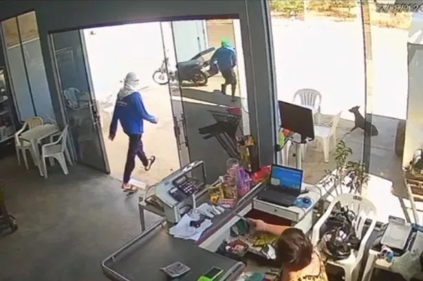 Woman captured on CCTV fighting off would-be robbers from her shop with machete