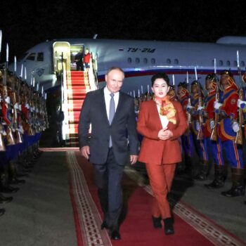 Russian President Vladimir Putin, on red carpet left, walks next to Mongolian Foreign Minister of Mongolia, Batmunkh Battsetseg upon his arrival at Ulaanbaatar's International airport Chinggis Khaan, late Monday, Sept. 2, 2024. (Natalia Gubernatorova, Sputnik, Kremlin Pool Photo via AP)