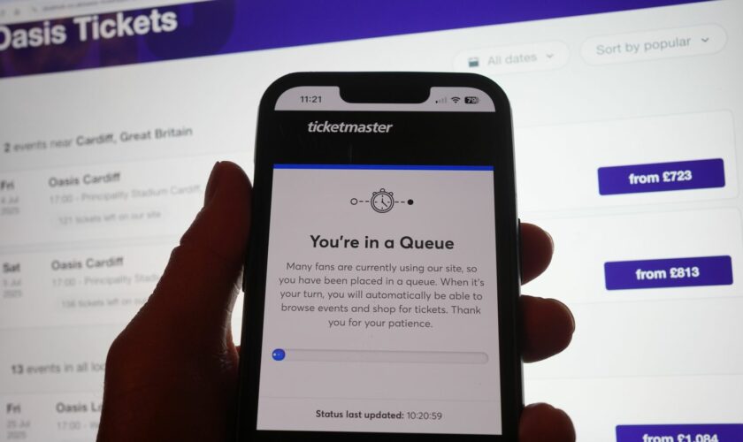 A person in a queue to access the Ticketmaster website on their phone, with the StubHub website in the background, detailing information about Oasis concert tickets for sale, in London. Oasis fans across the UK and Ireland who missed out on pre-sale tickets will be attempting to secure their place at the band's reunion concerts during Saturday's general sale. Issue date: Saturday August 31, 2024.