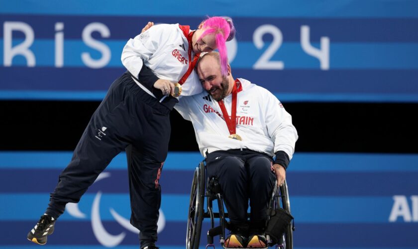 Nathan Macqueen and Jodie Grinham receive their gold. Pic: AP