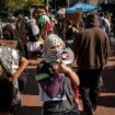 Masked anti-Israel protesters at Columbia University demonstrate as students check in for first day of classes