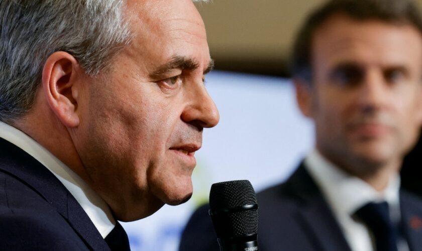 President of the Regional Council of Hauts-de-France Xavier Bertrand (L) speaks next to French President Emmanuel Macron at the Dunkirk Urban Community offices in Dunkerque, the city picked by Taiwanese company ProLogium to build a battery gigafactory plant, northern France, on May 12, 2023. (Photo by PASCAL ROSSIGNOL / POOL / AFP)