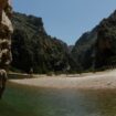 People sunbath at the "Torrent de Pareis" canyon, part of the cultural landscape of the Sierra de Tramuntana, on the northwestern coast of the Spanish Balearic island of Mallorca June 28, 2011. The cultural landscape of the Sierra de Tramuntana (Tramuntana mountain range) was inscribed on UNESCO's World Heritage List on Monday. REUTERS/ Enrique Calvo (SPAIN - Tags: ENVIRONMENT TRAVEL SOCIETY)