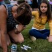 Brandy Rickaba and her daughter Emilie during a candlelight vigil for the victims of the school shooting. Pic: AP