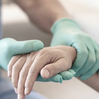 Surgeon, physician performs surgical operations, anesthetist or anesthesiologist holding patient's hand ffor checking state of mand or support in ER room, Medical healthcare concept