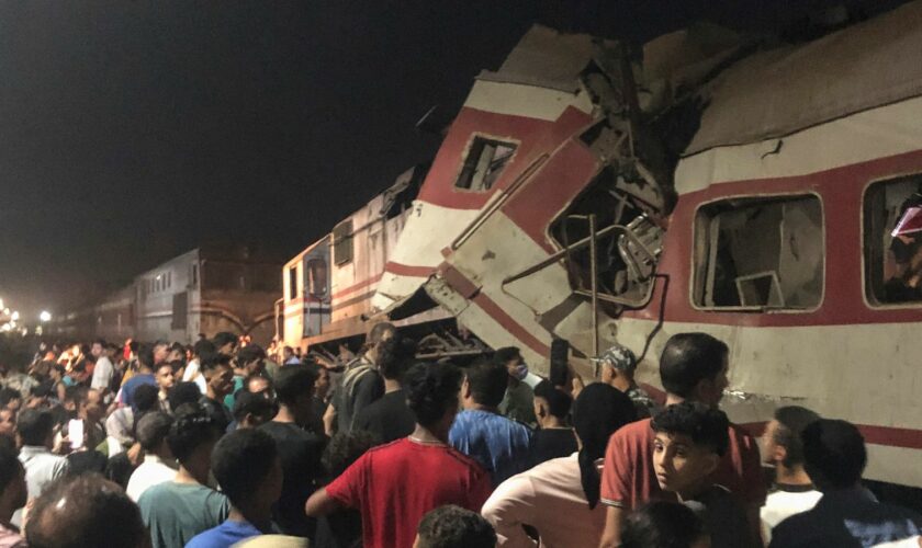 People surround two passenger trains which collided. Pic: AP