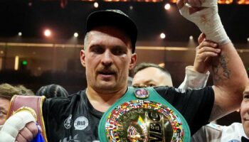 Oleksandr Usyk celebrates with the undisputed heavyweight title belt after his victory