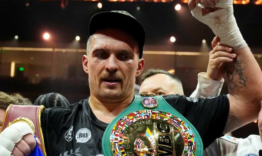 Oleksandr Usyk celebrates with the undisputed heavyweight title belt after his victory