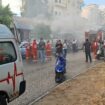 People gather as smoke rises from a mobile shop in Sidon, Lebanon September 18, 2024. REUTERS/Hassan Hankir