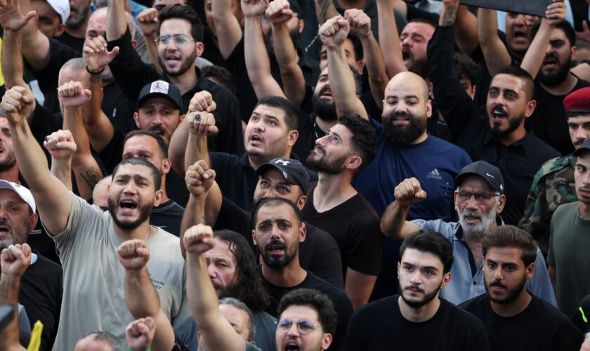 Men react as they attend the funeral for people who were killed amid the detonation of pagers across Lebanon, in Beirut, Lebanon September 18, 2024. REUTERS/Mohamed Azakir