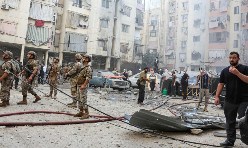 People and members of the military inspect the site of an Israeli strike in the southern suburbs of Beirut, Lebanon, September 20, 2024. REUTERS/Mohamed Azakir