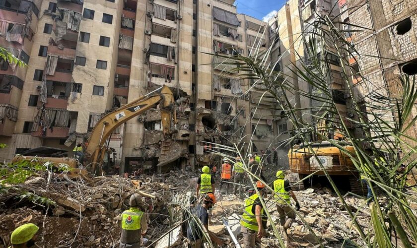 Anxious families line the pavement as dozens remain missing in the rubble after Beirut strike