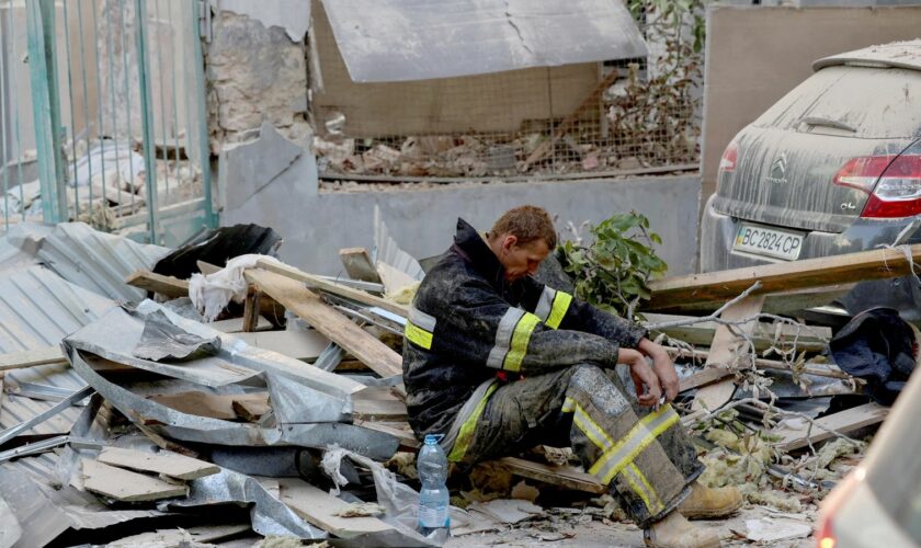 A rescuer rests at the site of a Russian drone and missile strike on residential buildings, amid Russia's attack on Ukraine, in Lviv, Ukraine September 4, 2024. REUTERS/Roman Baluk     TPX IMAGES OF THE DAY