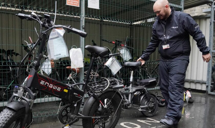 Sergeant Chris Hook handles confiscated illegally modified ebikes at Bishopsgate Police Station in London. Police seizures of illegally modified electric bikes (e-bikes) soared in the past year amid concerns their speed and weight present a lethal threat to pedestrians, according to Freedom of Information (FoI) figures obtained by the PA news agency. Forces across the UK confiscated 937 e-bikes in the year to August 11. Picture date: Thursday September 12, 2024.