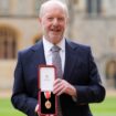 Sir Alan Bates shows off his award outside Windsor Castle. Pic: PA