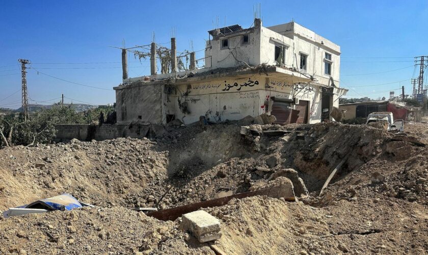 A crater on the side of a road after an Israeli airstrike on the side of the main coastal highway linking Aalma El Chaeb to Beirut