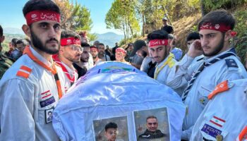 The coffin of a young boy is carried