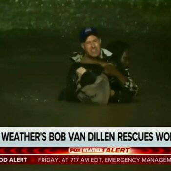 In this image made from a Fox Weather broadcast, meteorologist Bob Van Dillen rescues a woman stuck in floodwaters caused by Hurricane Helene in Atlanta, Friday, Sept. 27, 2024. (Fox Weather via AP)