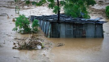 A tin shed lies partially submerged at the edge of the Bagmati River in spate after heavy rains in Kathmandu, Nepal, Saturday, Sept. 28, 2024. (AP Photo/Gopen Rai)