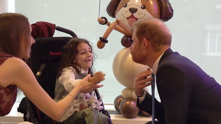 Prince Harry laughs as young boy pulls his beard at WellChild awards in London