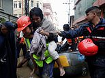 At least 170 dead after Nepal hit by flash flooding: Locals 'buried alive' as landslides sweep across country while families forced to wade through 'chest-deep' water to get to safety