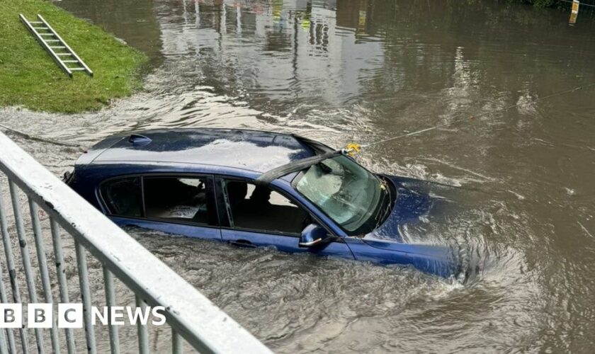 Cars and rail lines submerged as flood risk persists