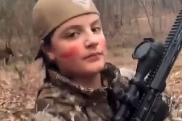 Chilling moment Georgia school shooting suspect, 14, posed with blood on face and AR-15