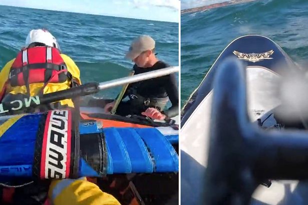 Dramatic moment windsurfer is thrown into the sea - but is saved by his 'only lifeline'