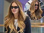 Elle Macpherson keeps her head down at Sydney Airport as she's seen for the first time since revealing she used unconventional treatment for breast cancer diagnosis