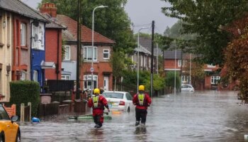 Flood warnings across UK as roads swamped by water and travel delays hit Britain