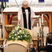 A priest stands next to the coffin of Sven-Goran Eriksson