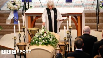 A priest stands next to the coffin of Sven-Goran Eriksson