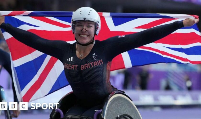 Hannah Cockroft with a Union Jack flag after winning the 800m title