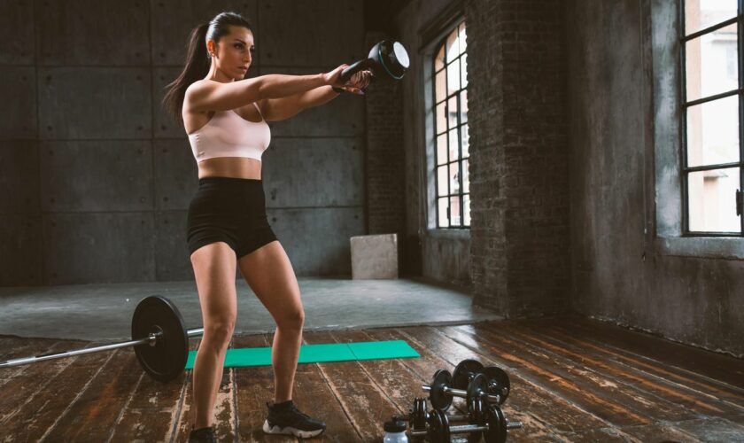 Sportarten ausprobieren: Frau beim Krafttraining mit Kettlebell