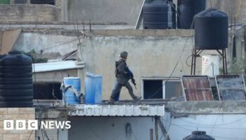 Israel investigates after its soldiers filmed throwing bodies off roof