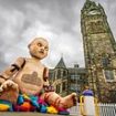 Locals 'freaked out' after giant baby doll puppet appears in town centre - but can YOU guess why it's there?