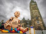 Locals 'freaked out' after giant baby doll puppet appears in town centre - but can YOU guess why it's there?