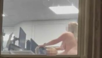 Moment randy office workers caught having sex in office in full view of busy street