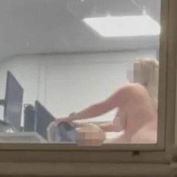 Moment randy office workers caught having sex in office in full view of busy street