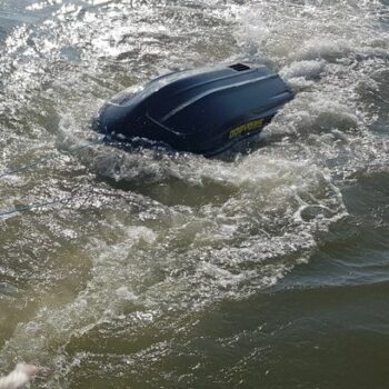 Rider swept out to sea clinging to upturned jet ski gets major stroke of luck