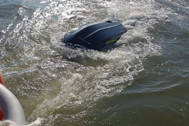 Rider swept out to sea clinging to upturned jet ski gets major stroke of luck