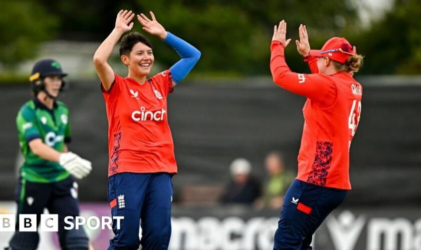 Issy Wong (left) and Hollie Armitage (right) celebrate a wicket for England against Ireland