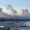 Smoke from several Israeli strikes seen from Lebanon beach