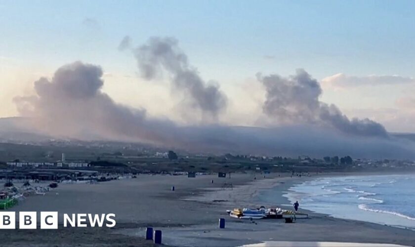 Smoke from several Israeli strikes seen from Lebanon beach