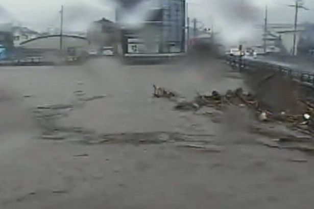 Terrifying moment entire street is submerged as killer floods hit Japan leaving one dead