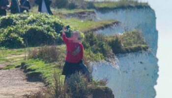 Tourist pictured risking life for selfie by 'very fragile' 530ft cliff edge at UK beauty spot