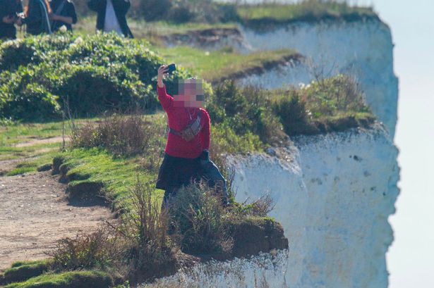 Tourist pictured risking life for selfie by 'very fragile' 530ft cliff edge at UK beauty spot