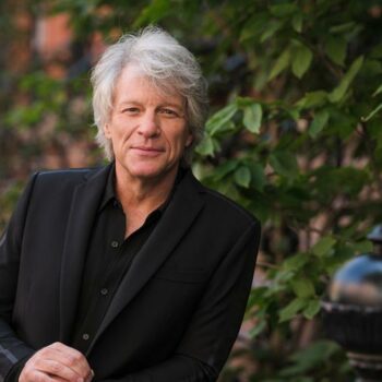 US musician Jon Bon Jovi helps woman standing on bridge edge