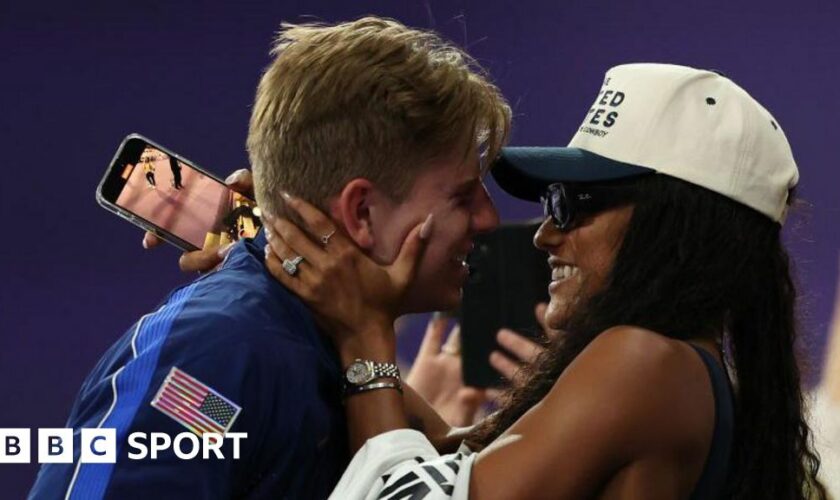 Hunter Woodhall hugging his wife Tara-Davis Woodhall after winning Paralympic gold