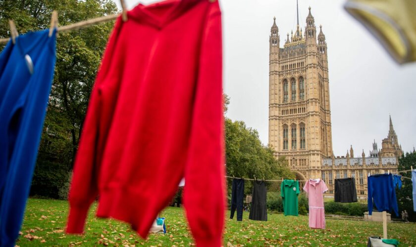 School uniform items hang out to dry on a clothes line in Westminster, London, as laundry brand smol and charity The Hygiene Bank launch their 'lean Up Child Hygiene Poverty campaign. Pic: PA